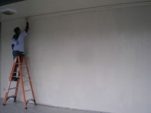 A volunteer paints during the 2011 ServeINC project.