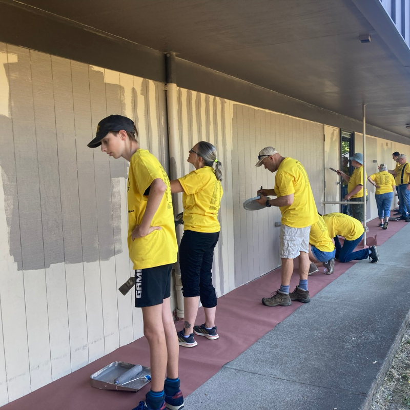 Pictured: Painters working together on a wall during the 2024 Day of Service.