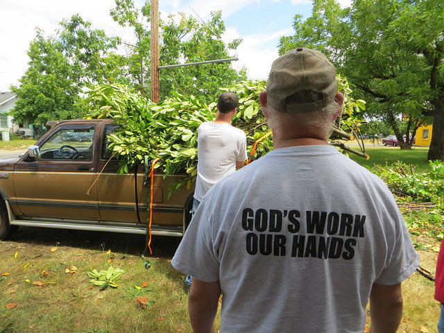 Transformations | A volunteers t-shirt read, "God Work, Our Hands."